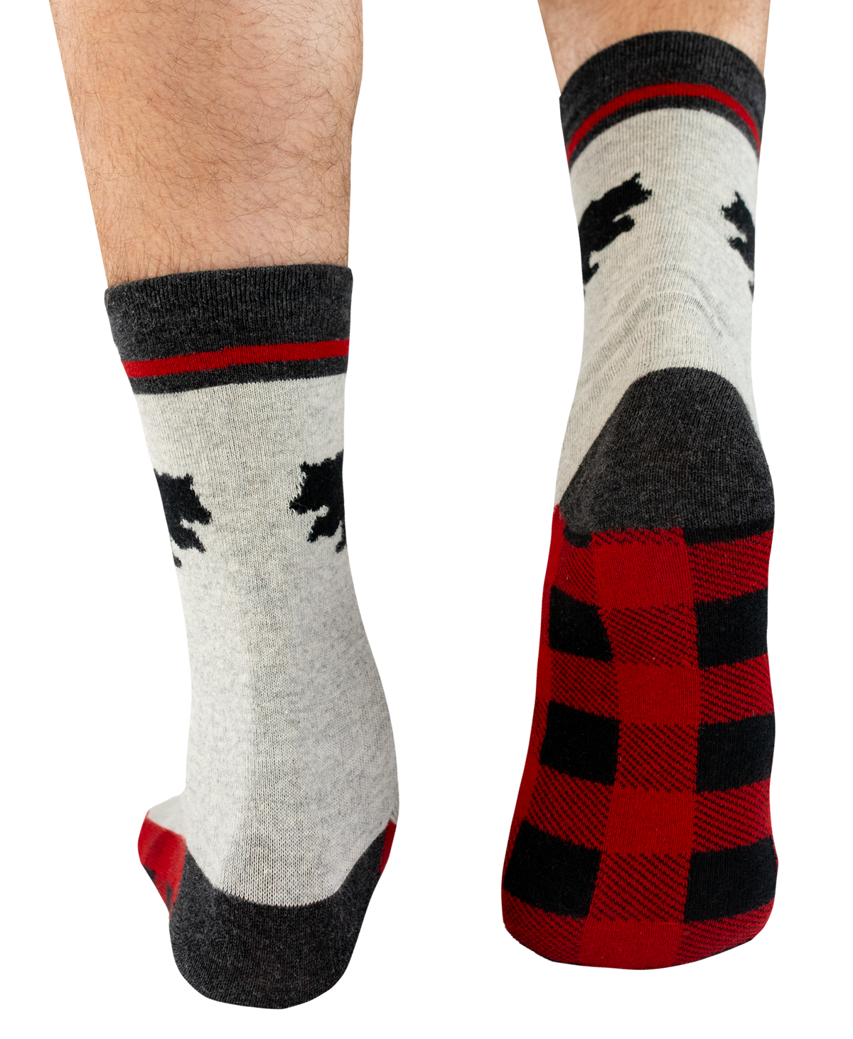 A pair of crew socks shown on human feet against a plain white background. The socks are light heather gray with black bear silhouettes, a red stripe near the cuff, a dark gray heel and toe, and a red-and-black buffalo plaid pattern on the sole.