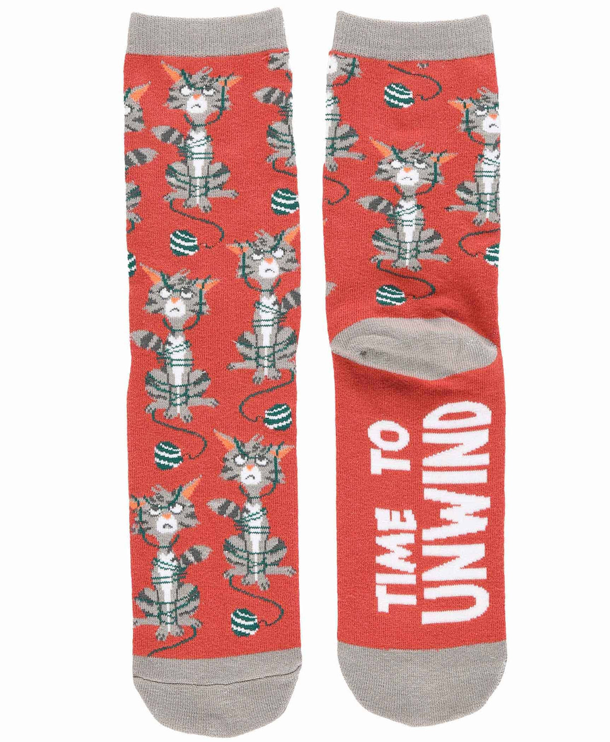 A pair of crew socks on a plain white background. The socks have a coral-red base with a repeating pattern of cartoon cats wrapped in yarn, plus white text reading 'TIME TO UNWIND' on one sock.