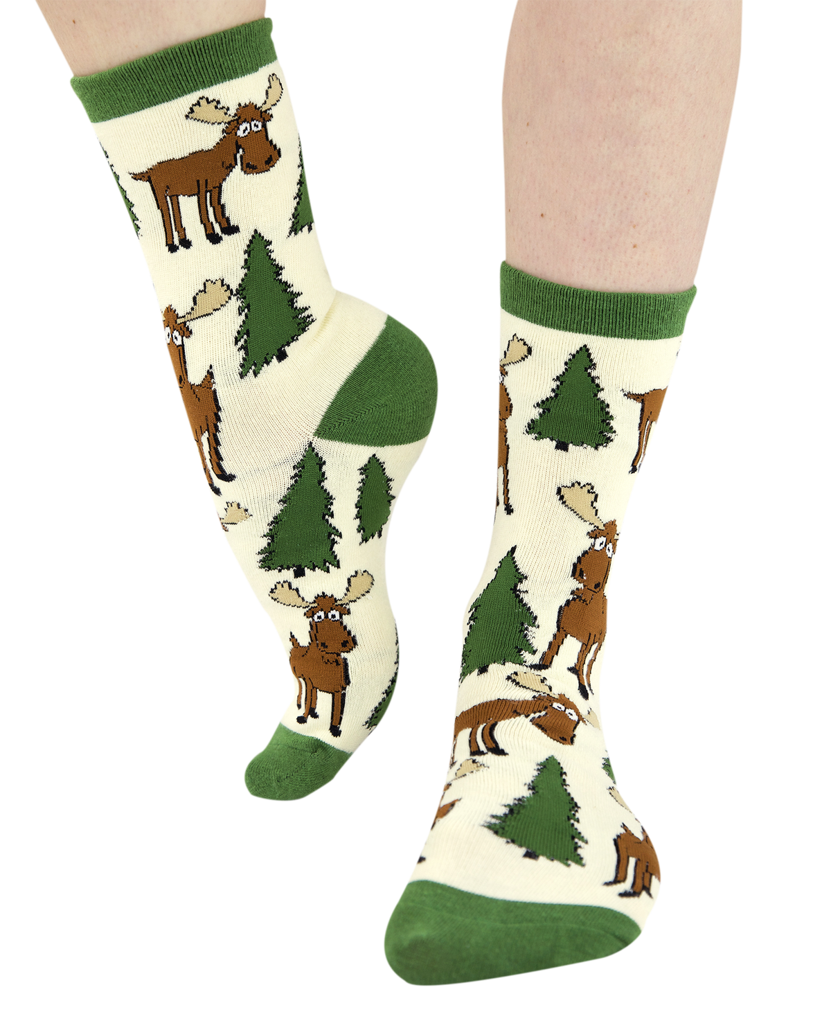 A pair of crew socks with a green and cream forest pattern featuring cartoon moose and pine trees, shown on a person's feet against a white background.