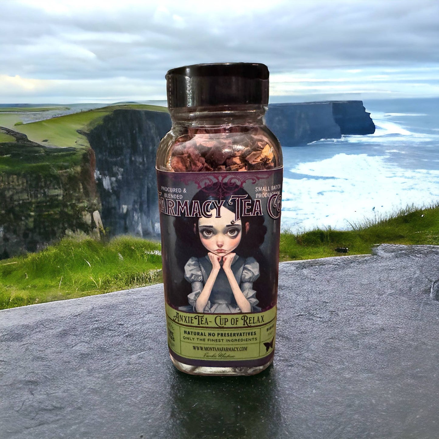 Bottle of 'MONTANA Farmacy Tea' with a scenic background of cliffs and ocea