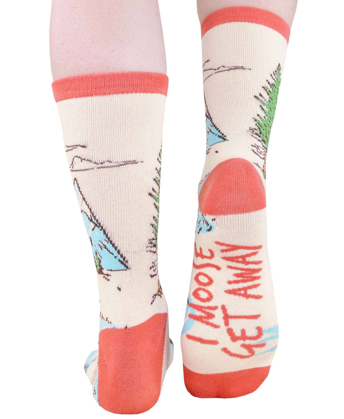 A pair of socks worn on legs, featuring a whimsical landscape print with mountains, trees, and the text 'I MOOSE GET AWAY' on the sole.