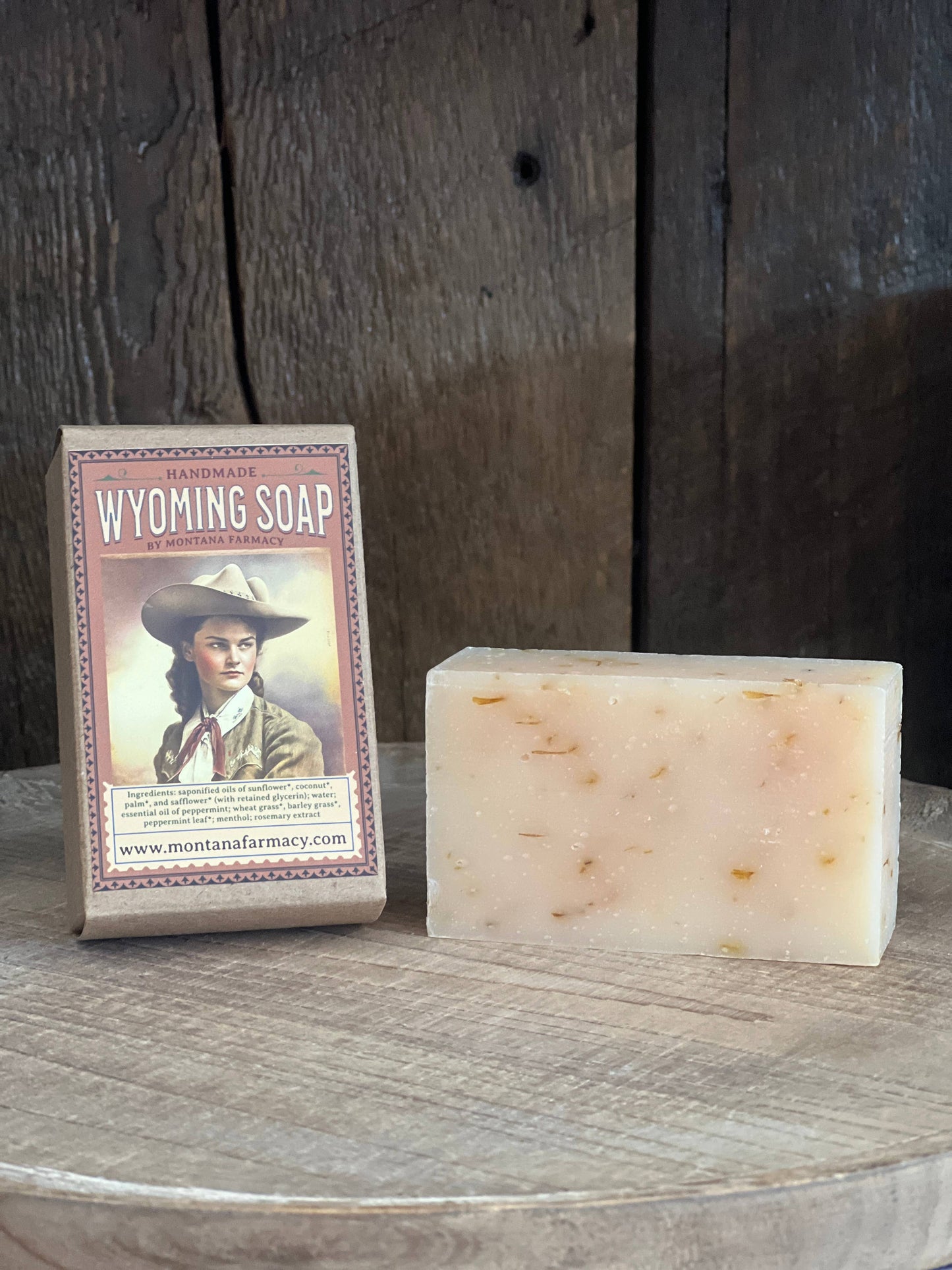 Wyoming Soap bar and packaging on a wooden surface with a rustic background