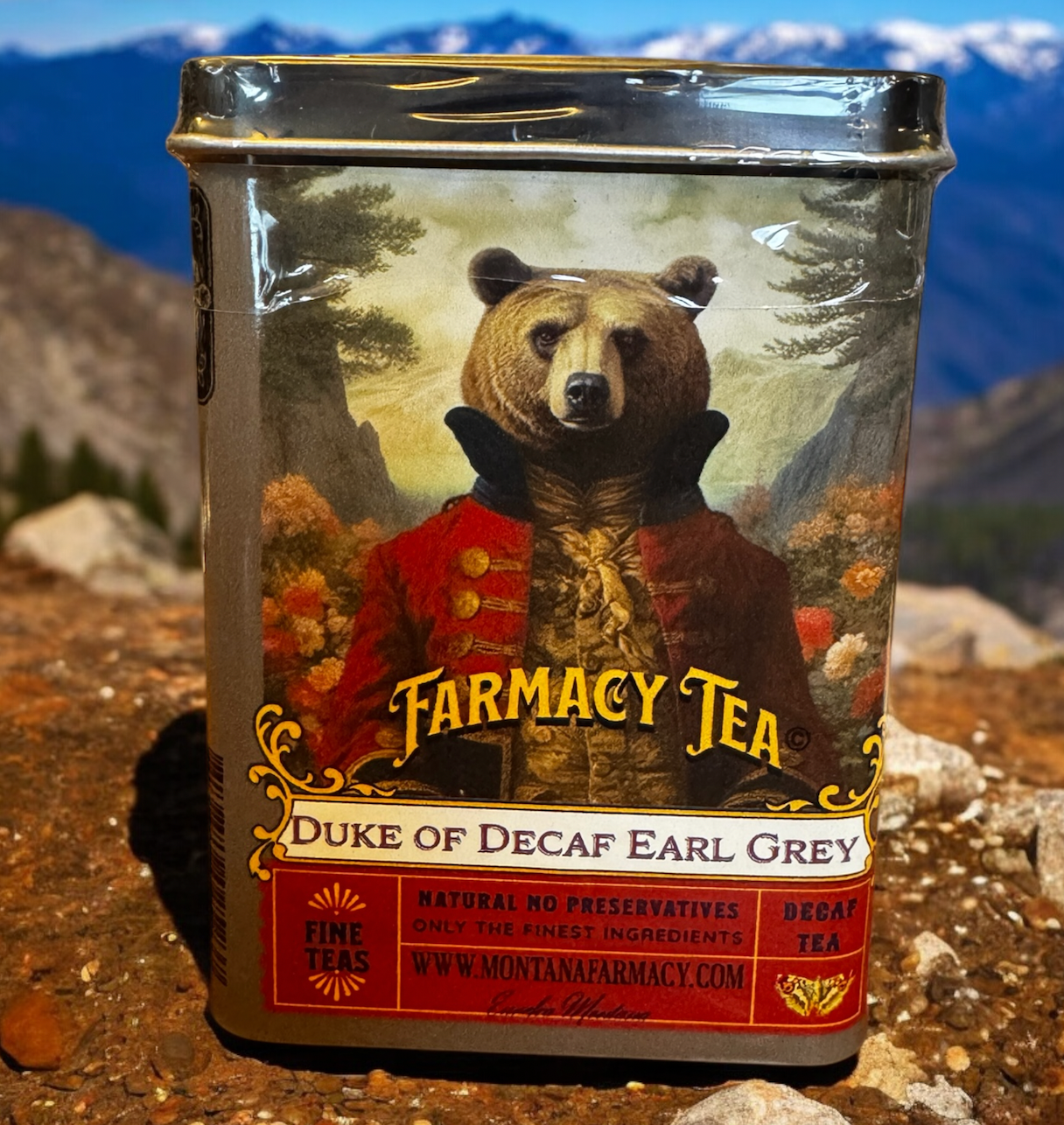 Tea canister with bear illustration labeled 'Farmacy Tea Duke of Decaf Earl Grey' on a mountainous background.