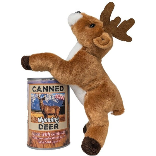 A plush toy deer standing on its back hooves against a can labeled "Canned Wyoming Deer" on a plain white background. The toy has brown fur, a white chest and muzzle, dark brown antlers, and dark brown hooves.