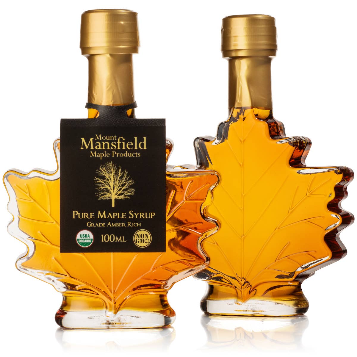 Two leaf-shaped bottles of Mount Mansfield Maple Products Pure Maple Syrup on a white background