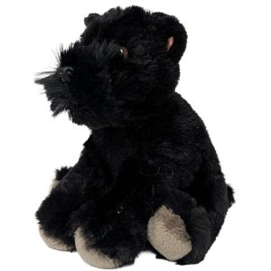 a black dog plush toy sitting next to a can on a white background