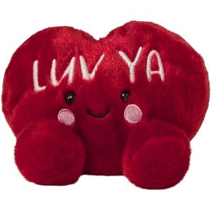 A red plush heart-shaped toy with white 'LUV YA' lettering and a smiling face sits  on a plain white background.