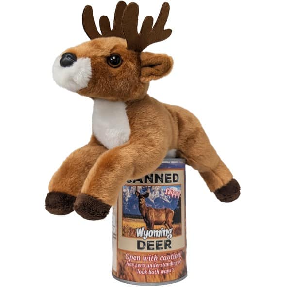 A plush toy deer lying down on a can labled "Canned Wyoming Deer". The toy has brown fur, a white chest and muzzle, dark brown antlers, and dark brown hooves. on a white background